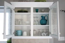 Kitchen utensils behind glass photo