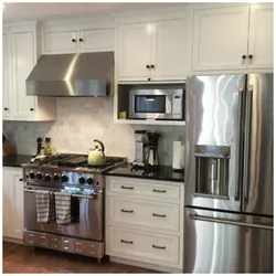 Kitchen photo with microwave and TV