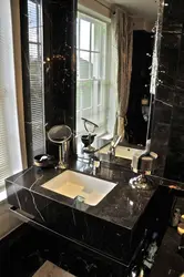 Dark countertop in the bathroom photo