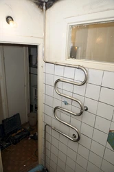 Heated towel rail pipe in the bathroom photo
