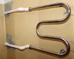 Heated towel rail pipe in the bathroom photo