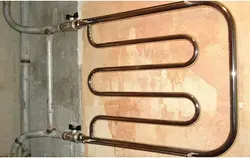 Heated towel rail pipe in the bathroom photo