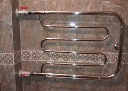 Heated towel rail pipe in the bathroom photo