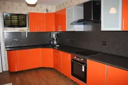 Orange kitchen black countertop photo