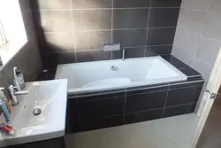 Acrylic bathtub in tiles photo