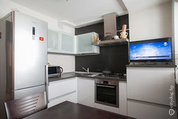 Photo Of A Kitchen With A Refrigerator And A Table