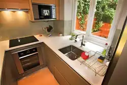 Photo of a kitchen with a refrigerator and a table