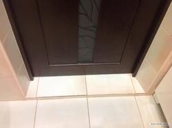 Photo of bathroom tiles near the door