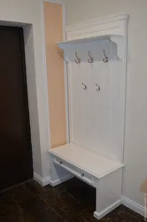Photo of a hanger in the hallway with a seat