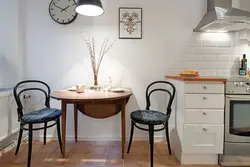 Photo of a small kitchen table against the wall