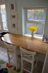 Photo of a small kitchen table against the wall