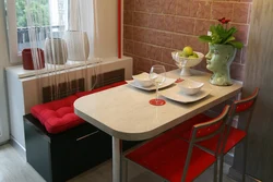 Photo of a small kitchen table against the wall