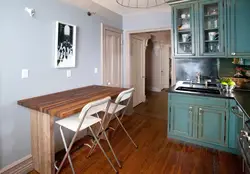 Photo of a small kitchen table against the wall