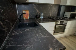 Kitchen with black marble countertop photo