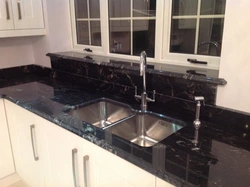 Kitchen with black marble countertop photo