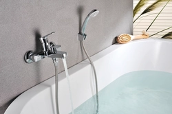 Bathtub and faucets with long photo