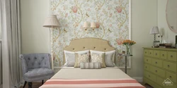 Photo of a bedroom with flowers at the headboard