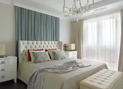 Photo of a bedroom with flowers at the headboard