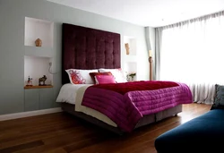 Photo of a bedroom with flowers at the headboard