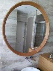 Wooden bathroom mirror photo