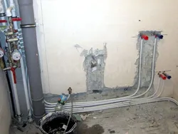 Pipes in the floor in the bathroom photo