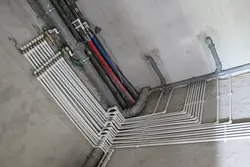 Pipes in the floor in the bathroom photo