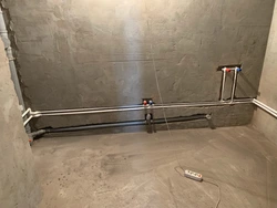 Pipes in the floor in the bathroom photo