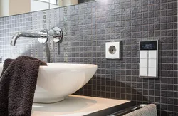 Socket and switch in the bathroom photo