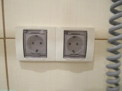 Socket and switch in the bathroom photo