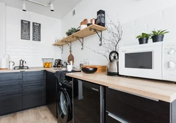 Black washing machine in the kitchen photo