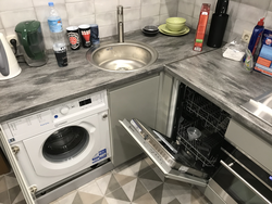 Black washing machine in the kitchen photo