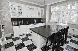 White kitchen on black tiles photo