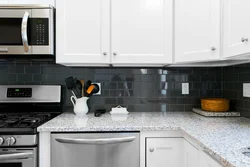 White kitchen on black tiles photo