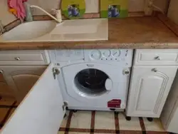 Washing machine with sink in the kitchen photo
