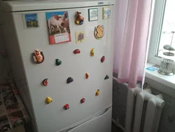 Refrigerator near the radiator in the kitchen photo