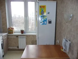 Refrigerator Near The Radiator In The Kitchen Photo