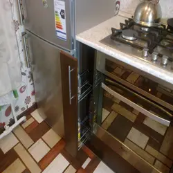Refrigerator near the radiator in the kitchen photo