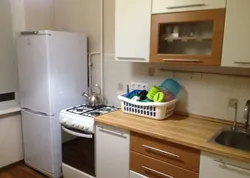 Refrigerator near the radiator in the kitchen photo