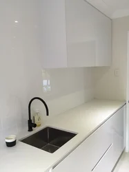 Sink on a light kitchen countertop photo