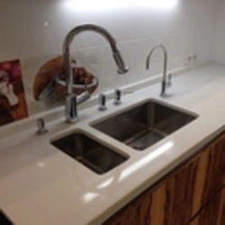 Sink on a light kitchen countertop photo