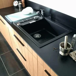 Sink on a light kitchen countertop photo