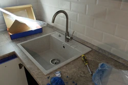 Faucet on the countertop in the kitchen photo