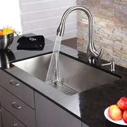 Faucet on the countertop in the kitchen photo