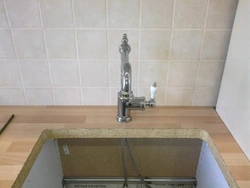 Faucet on the countertop in the kitchen photo
