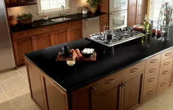 Black kitchen with brown countertop photo