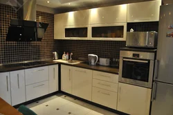 Black kitchen with brown countertop photo