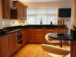 Black kitchen with brown countertop photo