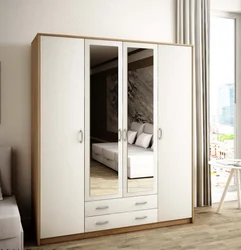 White wardrobe with mirror in the bedroom photo