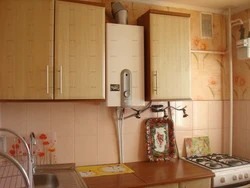 Kitchen with gas boiler and refrigerator photo