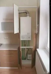 Kitchen with gas boiler and refrigerator photo